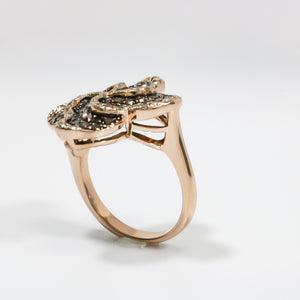 ROSE GOLD LADY'S SWIRL RING WITH BROWN AND WHITE DIAMONDS.